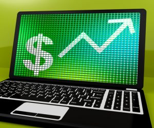 Dollar Sign And Up Arrow On Laptop For Earnings Or Profit